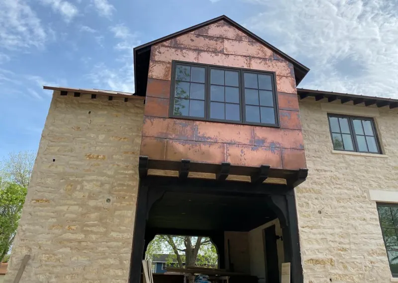 Copper metal panel facade on a stone building for Skylight Installation in Satsuma