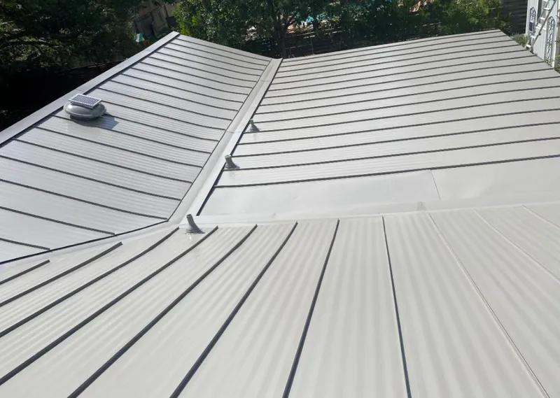 Solar attic fan installed on a metal roof for Roof Ventilation in Satsuma